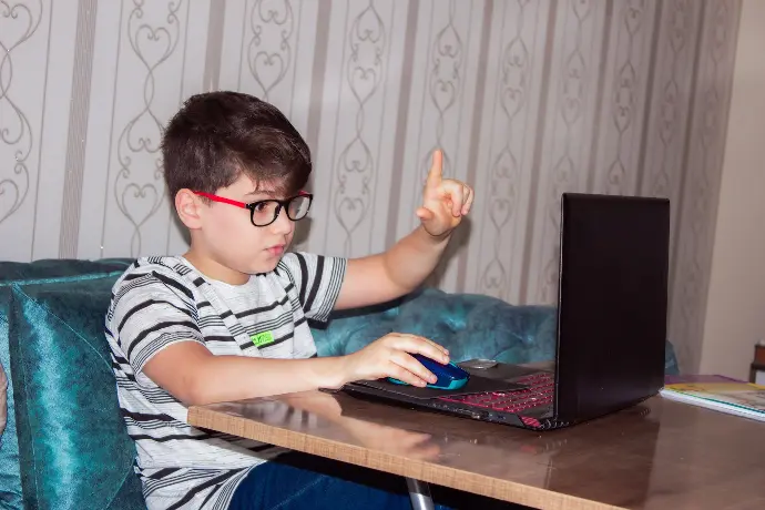 Online tutor man in black and white stripe shirt using black laptop computer